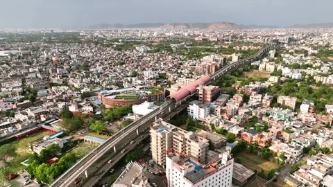 Metro Train Moving Through Jaipur City Skyline Captured from Drone in India Stock Footage 310003832