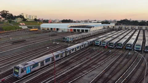 Metro Train Moving Through Railway Depot at Sunset Stock Footage 340536912
