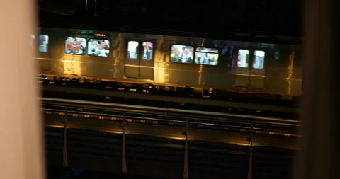 Metro train with passengers moving at night in Istanbul, slow motion Stock Footage 318680757