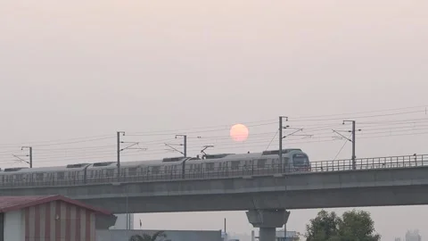 Metro train passing over bridge during sunset time in jaipur city. Stock Footage 148929816