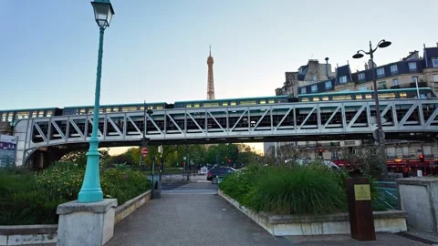 Metro Train Passing Over Bridge at Sunrise with Eiffel Tower View in Central Vidéo 336250621