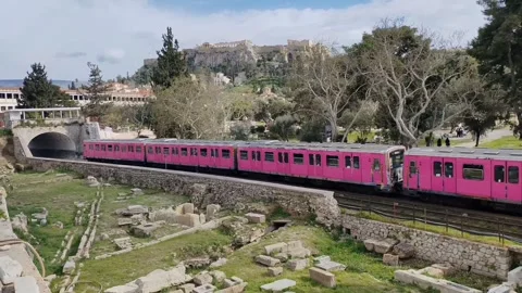 Metro train passing through the Ancient Agora of Athens Stockbeeldmateriaal 333974846