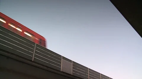 Metro train runs on bridge and a pan to traffic in Helsinki in winter Video stock 84062634
