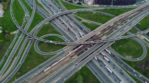 Metro train slices between busy highways, aerial view captures seamless urban Stock Footage 273378656