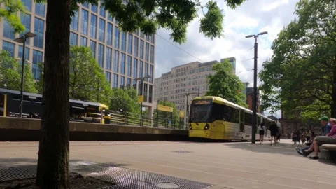 Metrolink tram pulls alongside the platform. Video stock 242433361