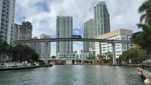 The Metromover train is crossing bridge above Miami River. Downtown Miami Stock Footage 328348282