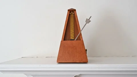 Metronome beating on a White Shelf Stock Footage 158861153