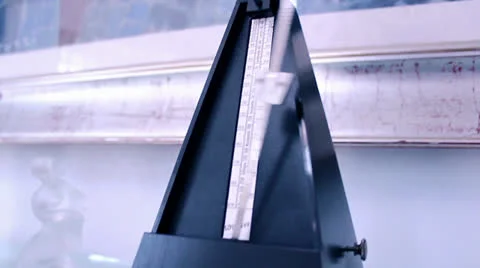 METRONOME WITH GLASS STATUES Stock Footage 25790219