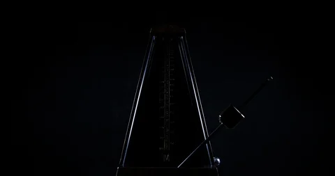 Metronome with golden pendulum beats slow rhythm on the dark background 스톡 동영상 87820211