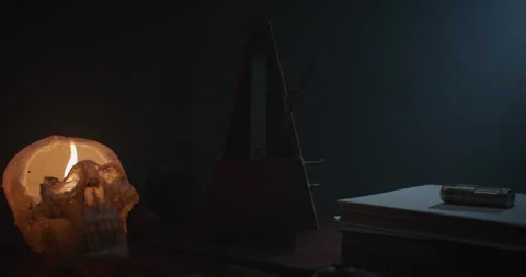 Metronome Pendulum and a skull candle Stock Footage 255758905