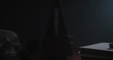 Metronome Pendulum and a skull on the table Stock Footage 255759771