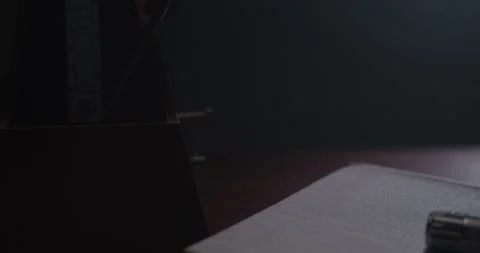 Metronome Pendulum Beating in the dark Stock Footage 255759482