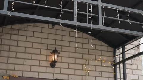 Metropolitan brick structure illuminated by cozy holiday lighting. Cityscape Stock Footage 335764882