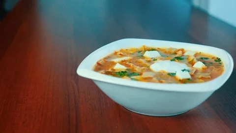 Mexican chilli bean soup, served with guacamole and cream. Stock Footage 103223283