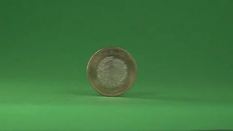 A Mexican coin rolling on a chroma background. Stock Footage 141638254