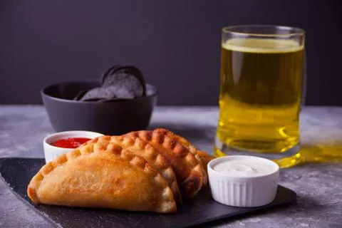 Mexican corn chips nachos, fried meat pies empanadas cheburek with dips and g Photos