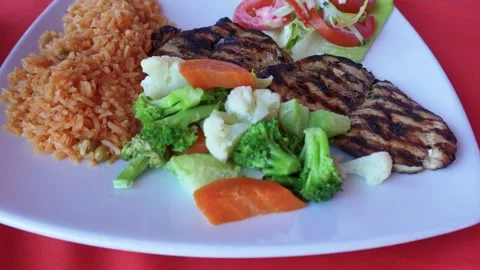Mexican dish with rice, vegetable, grilled chicken and salad Video stock 294892964