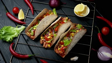 The Mexican dish of Tako corn flat cake with vegetable filling on a wooden board Stock Footage 156521715
