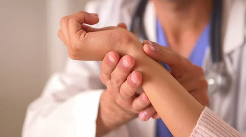 Mexican doctor checking woman's pulse Stock-Footage 25628664