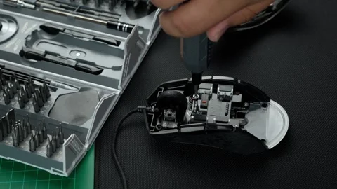 A mexican electronic technician in the workshop repairing a wired mouse Stock Footage 274859249
