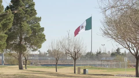 Mexican Flag Blowing in the Wind Near the Border 2 Stock Footage 60408510