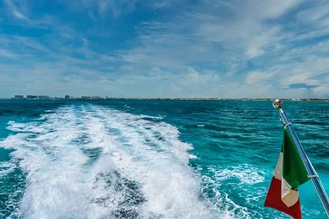 Mexican flag on ship boat ferry in Caribbean Ocean near Cancun, Yucatan, Mexi Stock Photos