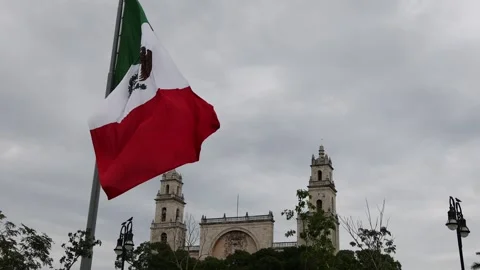 Mexican flag waving in the cathedral in merida yucatan mexico Stock Footage 304905992
