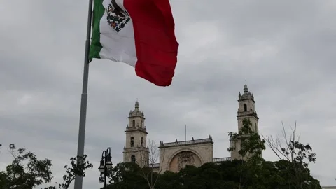 Mexican flag waving in the cathedral in merida yucatan mexico Stock Footage 304906102