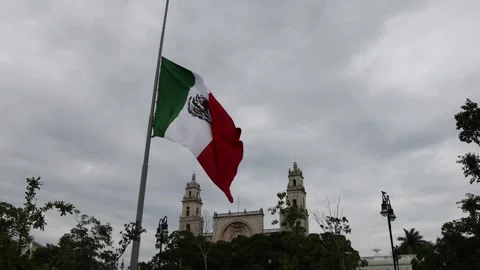 Mexican flag waving in the cathedral in merida yucatan mexico Stock Footage 304906257