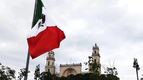 Mexican flag waving in the cathedral in merida yucatan mexico Stock Footage 304906260