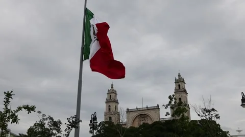 Mexican flag waving in the cathedral in merida yucatan mexico Stock Footage 304906384