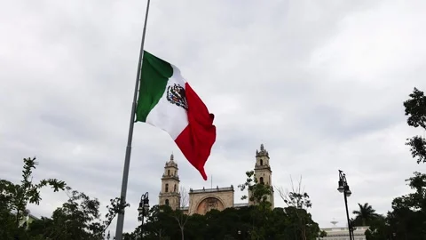 Mexican flag waving in the cathedral in merida yucatan mexico Stock Footage 304906403