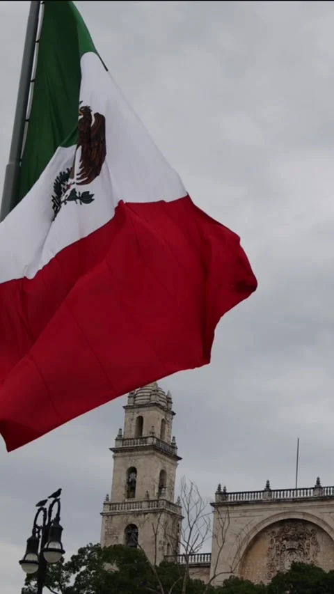 Mexican flag waving in the cathedral in merida yucatan mexico Stock Footage 304906408
