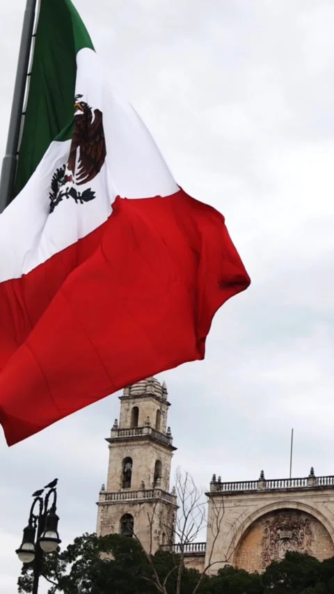 Mexican flag waving in the cathedral in merida yucatan mexico Stock Footage 304906520