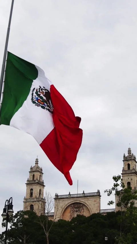 Mexican flag waving in the cathedral in merida yucatan mexico Stock Footage 304906522