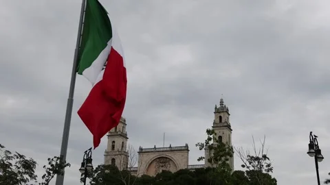 Mexican flag waving in the cathedral in merida yucatan mexico Stock Footage 304909621