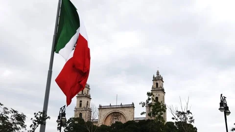 Mexican flag waving in the cathedral in merida yucatan mexico Stock Footage 304909757