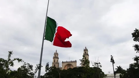 Mexican flag waving in the cathedral in merida yucatan mexico Stock Footage 304909845