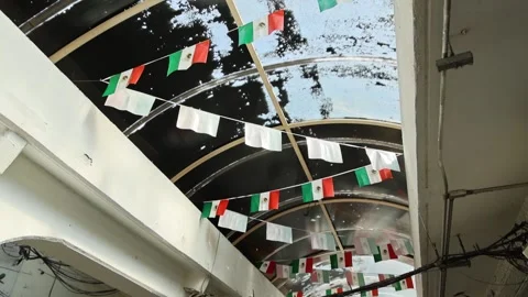 Mexican Flags And White Banner Strings Hanging Under Covered Market Walkway 库存影片 343995560