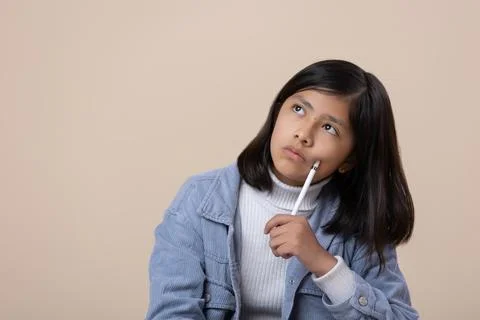 Mexican girl sitting on the floor thinking expression with stylu Stock Photos