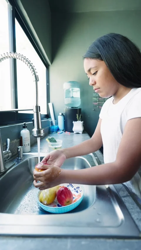 Mexican Girl Washing Fruit in Kitchen Sink, Disinfecting Stock Footage 277222353