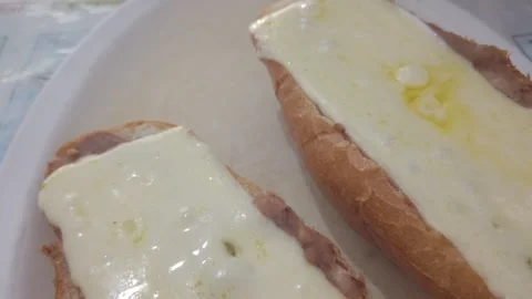 Mexican Molletes: Open-Faced Bread with Melted Cheese and Refried Beans Stock Footage 322556794