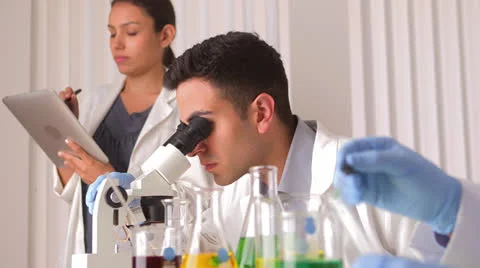 Mexican scientist collaborating with colleague Видео 25630197