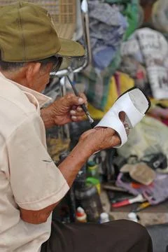 A Mexican shoemaker at work Stock Photos