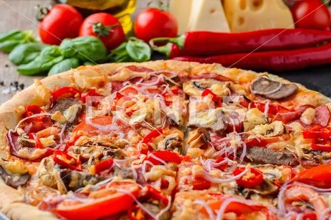 Mexican spicy pizza and ingredients on a wooden table. Traditional Italian cu Stock Photos