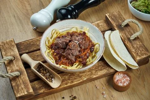 Mexican style noodles - corn paste with chili con carne, stewed beef and taco Stock Photos