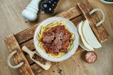 Mexican style noodles - corn paste with chili con carne, stewed beef and taco Stock Photos
