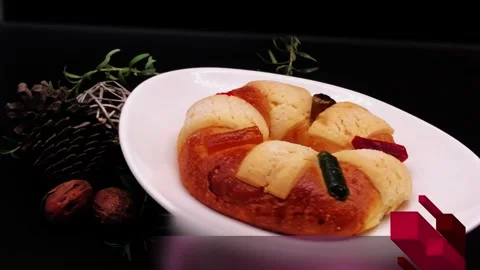 Mexican Three Kings bread with candied fruit, on black background turning Stock Footage 314675071