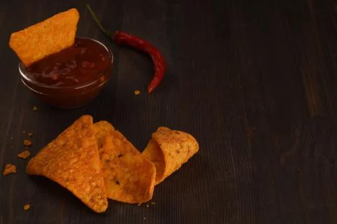 Mexican triangular chips with salsa sauce and chilli pepper.Copy space Stock Photos