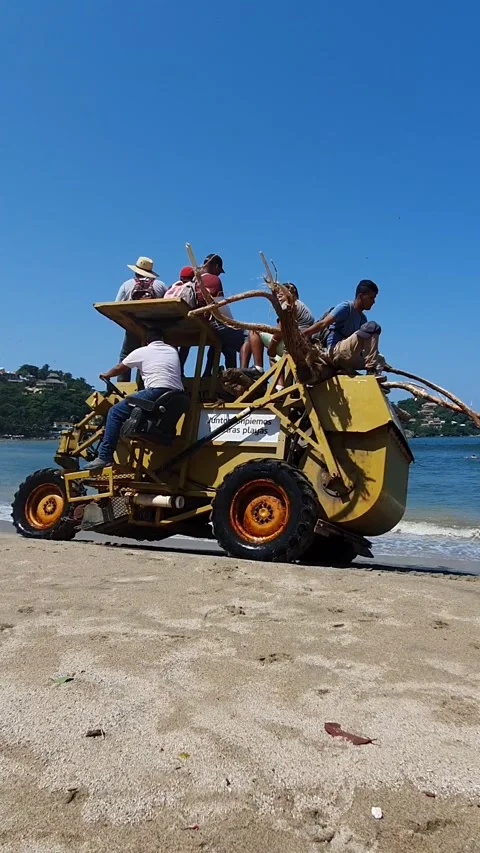 Mexicans traveling on beach by tractor Stock Footage